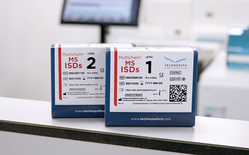 Multichem MS ISDs kit box in laboratory with analyzer in background.
